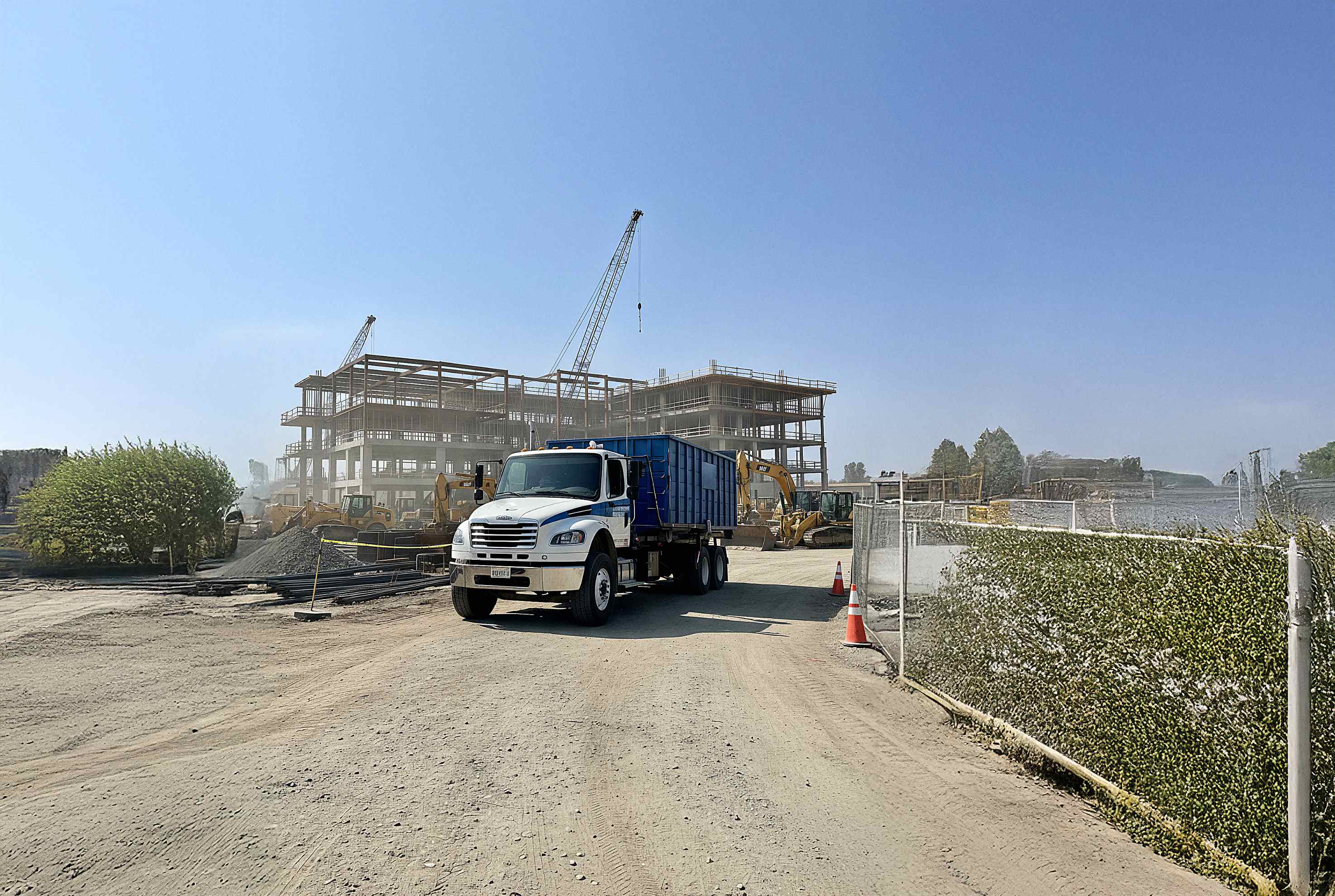 WRS roll-off dumpster truck at a construction site